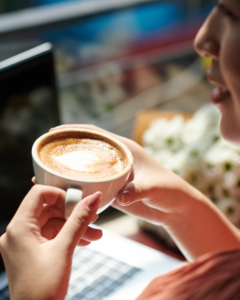 Employee drinking coffee at their desk